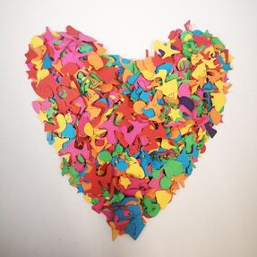 Laser cut paper shapes stacked in the shape of a heart