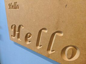 Wooden board with CNC Hello engraved